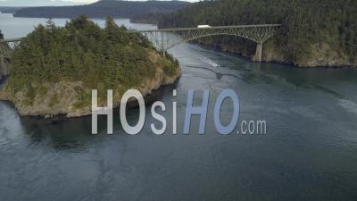 Aerial Film Of Boat Cruising Under Washington State Famous Bridge At Deception Pass - Video Drone Footage