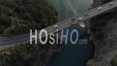Flying Over Travelers In Commute On High Bridge With Tall Cliffs From Pacific Ocean Islands. Deception Pass Washington Usa - Video Drone Footage