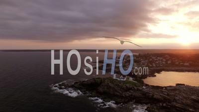 Flying Low Around Nubble Lighthouse Panning At Sunset. York Maine - Video Drone Footage