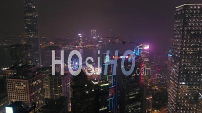Hong Kong Flying Low Over Central District Panning Down With Cityscape Views At Night. - Video Drone Footage