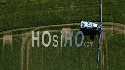 Aerial View Of A Tractor Spraying Field