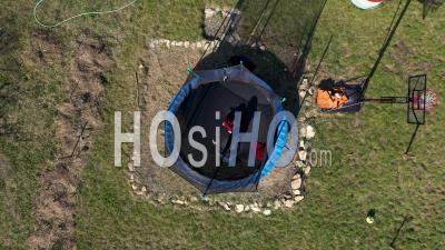 Video Drone Footage Of Mother With Kid Jumping On Trampoline
