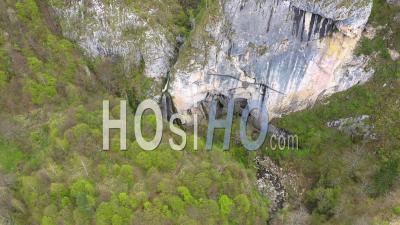 Video Drone Footage Of A Big Cave Entrance And Waterfall In The Mountains