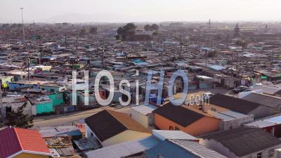 Aerial View Over Gugulethu, One Of The Poverty Stricken Slums, Ghetto, Or Townships Of South Africa - Video Drone Footage
