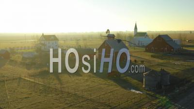 Aerial Video Drone Footage At Dawn Establishing Shot Over A Classic Farmhouse Farm And Barns In Rural Midwest America, York, Nebraska