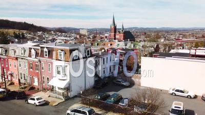 Rising Aerial View Of Typical Pennsylvania Town With Rowhouses And Large Church Or Cathedral Distant, Reading, Pa - Video Drone Footage