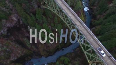 Aerial View Of A Pickup Truck Traveling Over A Steel Suspension Bridge Over The Skokomish River In Washington, Usa - Video Drone Footage