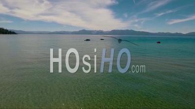 An Aerial View Of A Woman Paddling A Kayak Across Lake Tahoe - Video Drone Footage