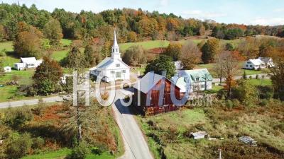 Aerial View Over A Charming Small Village Scene In Vermont With Church, Road And Farm - Video Drone Footage
