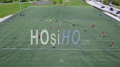 Aerial View Over An Amateur Soccer Match On A Soccer Field - Video Drone Footage