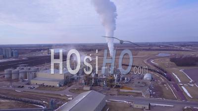 Aerial View Over An Oil Refinery Spewing Pollution Into The Air - Video Drone Footage
