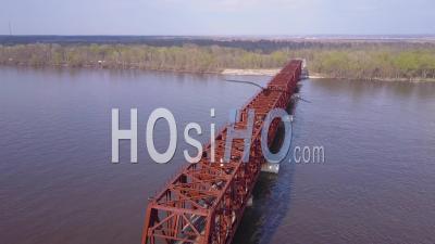 Aerial View Of A Large Steel Suspension Bridge Over The Mississippi River Near Burlington Iowa - Video Drone Footage
