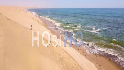 Aerial View Over A Model Released Woman Walking On Magnificent Sand Dunes On The Skeleton Coast, Namibia - Video Drone Footage