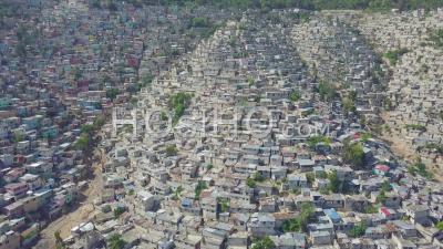 Aerial View Of The Endless Slums, Favelas And Shanty Towns In The Cite Soleil District Of Port Au Prince, Haiti With Soccer Stadium Foreground - Video Drone Footage