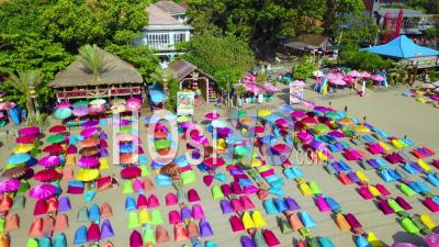 Aerial View Over Colorful Beach Umbrellas In Sanur Or Kuta Beach On The Coast Of Bali, Indonesia - Video Drone Footage