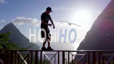 A Man Dances On The Balcony Of A Hotel At A Resort On The Caribbean Island Of St. Lucia - Video Drone Footage