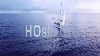 Aerial View Of Young People On A Sailboat Sailing Across The Caribbean Ocean Sea Near The Island Of St. Vincent - Video Drone Footage