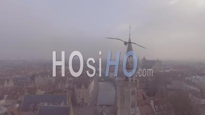 Aerial View Of A Mysterious Foggy Day In Bruges, Belgium With Cathedral Churches And Spires In Distance - Video Drone Footage
