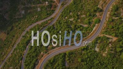 Aerial View Of Cars Navigating On A Very Narrow Winding Mountain Road With Many Switchbacks And Hairpin Turns - Video Drone Footage