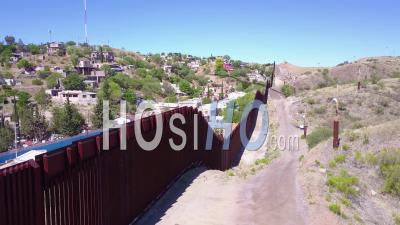 Aerial View Along The U.S Mexican Border Wall Fence Reveals The Town Of Nogales - Video Drone Footage