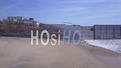 Aerial View Reveals The U.S. Mexico Border Fence In The Pacific Ocean Between San Diego And Tijuana - Video Drone Footage