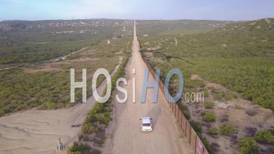 Aerial View Over A Border Patrol Vehicle Standing Guard Near The Border Wall At The Us Mexico Border - Video Drone Footage