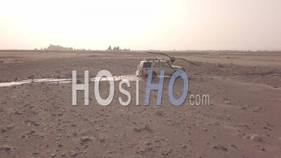 Aerial View Over A 4x4 Jeep Traveling Across The Deserts Of Djibouti Or Somalia - Video Drone Footage
