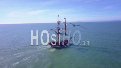 Aerial View Of A Tall Sailing Ship On The Open Ocean By Day - Video Drone Footage