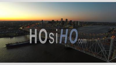 Beautiful Night Aerial View Of The Crescent City Bridge Over The Mississippi River Revealing The New Orleans Louisiana Skyline - Video Drone Footage