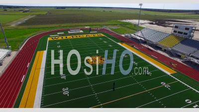 Aerial View Over A Coach And Player Practicing On A Modern High School Football Stadium Field - Video Drone Footage