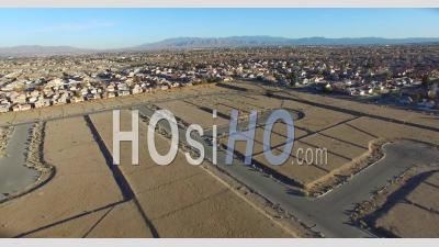 Aerial View Over Desert Reveals Housing Tracts And Empty Lots In The Desert - Video Drone Footage
