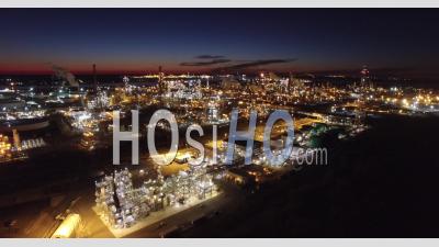 Aerial View Over Huge Industrial Oil Refinery At Night - Video Drone Footage