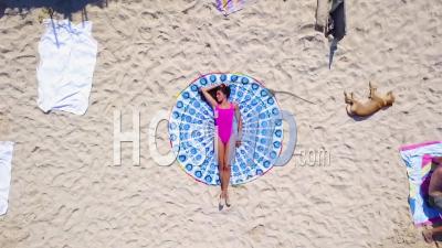 Aerial View Straight Down And Rising Of A Woman On A Crowded Beach In Cartagena, Colombia - Video Drone Footage