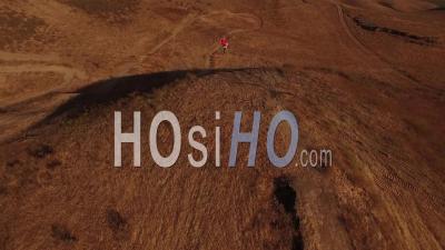 Aerial View Over A Motocross Motorcyle Rider Jumping And Getting Air - Video Drone Footage