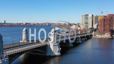 Aerial View Of City Skyline Of Cambridge Boston Massachusetts With Longfellow Bridge And Subway Train Crossing - Video Drone Footage