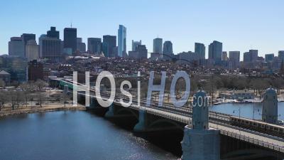 Aerial View Of City Skyline Of Boston Massachusetts With Longfellow Bridge And Subway Train Crossing - Video Drone Footage