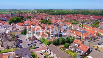 Aerial View Over Classic Dutch Holland Town With Prominent Windmill, Sluis, Netherlands - Video Drone Footage