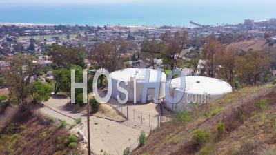 Aerial View Over Water Tanks High On A Hill Above The City Of Ventura, California - Video Drone Footage