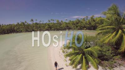 Aerial View Of A Girl Walking In A Tropical Lagoon - Video Drone Footage