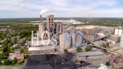 Cement Factory With Open Pit Quarry In Background, Sweden - Video Drone Footage