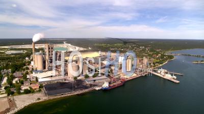 Aerial View From Ocean Over Cement Factory, Sweden - Video Drone Footage