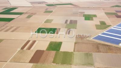 Aerial View Of (wide Shot) Patchwork Fields And Photovoltaic Plant
