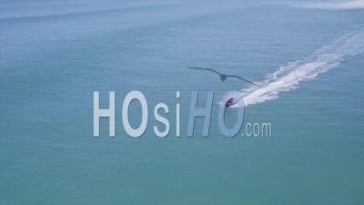 Men On Jetski At Full Speed On A Blue Ocean - Video Drone Footage