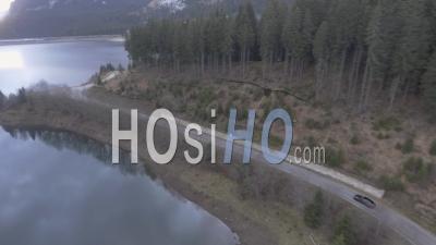 Car Driving On A Lakeside Road - Video Drone Footage