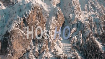 Mountains And Pine Forest Covered In Snow - Video Drone Footage