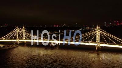 Car Driving On Albert Bridge In London, At Night - Video Drone Footage