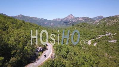 Riding A Scooter In The Mountains Of Montenegro. Drone Follow Shot