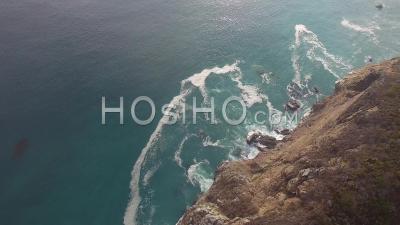 Cliff With Ocean Waves Crashing Onto Rocks - Video Drone Footage