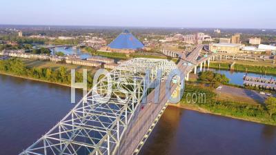 Memphis Tennessee Across The Mississippi River With Hernando De Soto Bridge Foreground And Memphis Pyramid Background - Aerial Video By Drone
