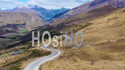 2019 - Aerial Video Over A Road In The South Island Of New Zealand Reveals Queenstown And Remarkables Mountain Range Distant - Video Drone Footage